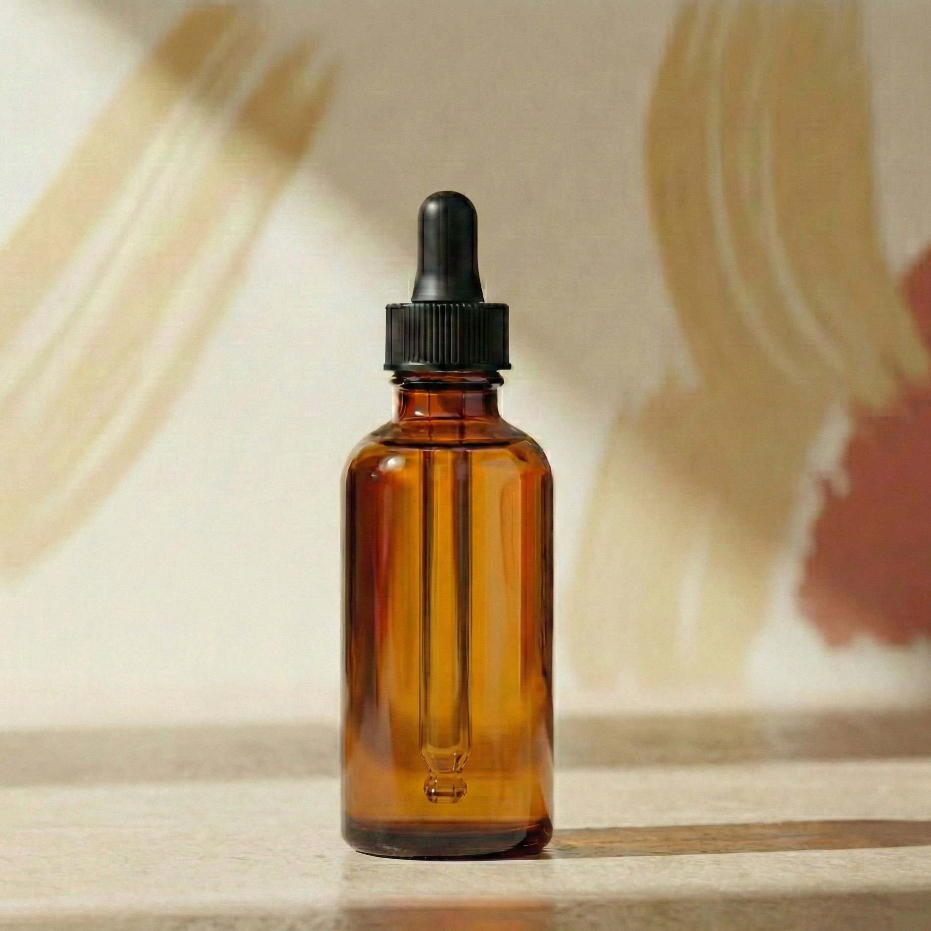 Brown glass dropper bottle on a wooden surface with a blurred abstract background