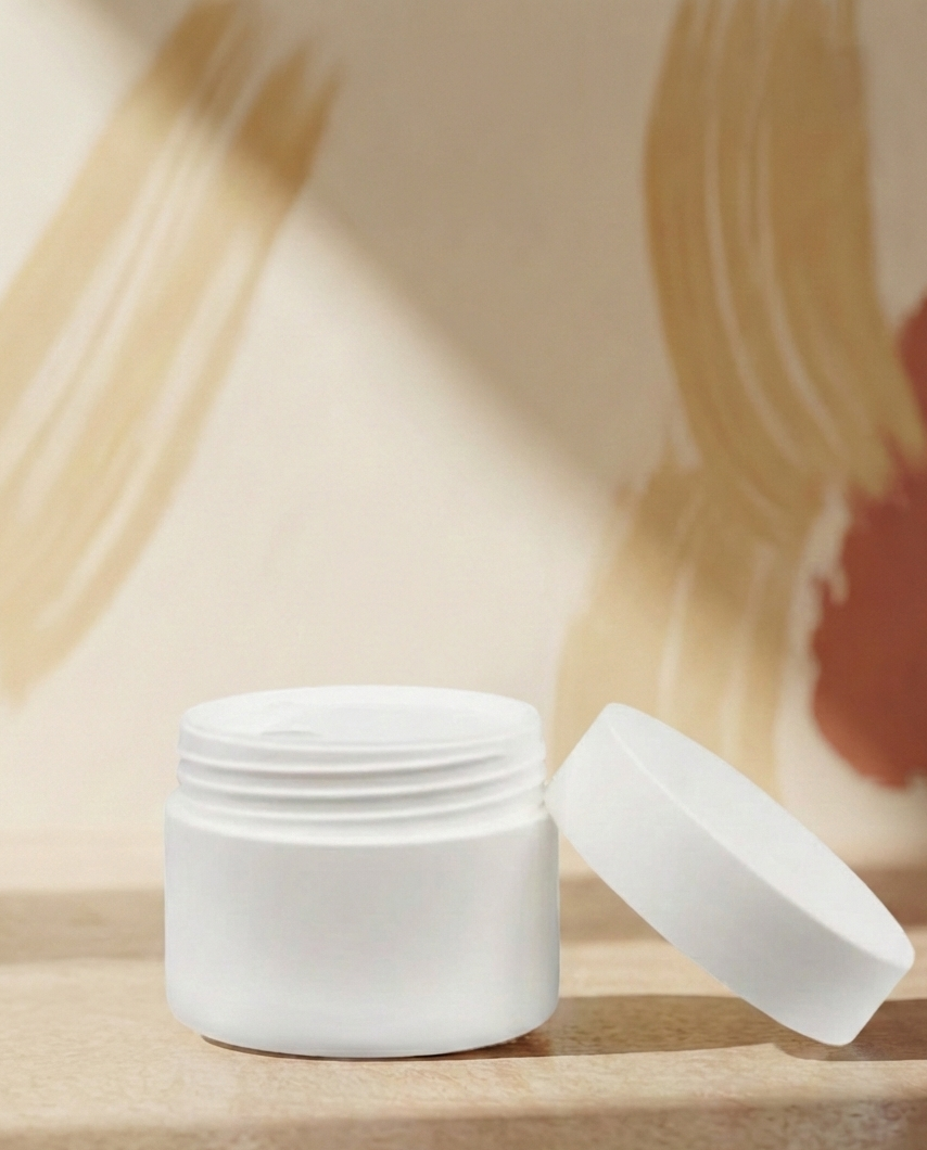 White cosmetic jar with lid on a wooden surface